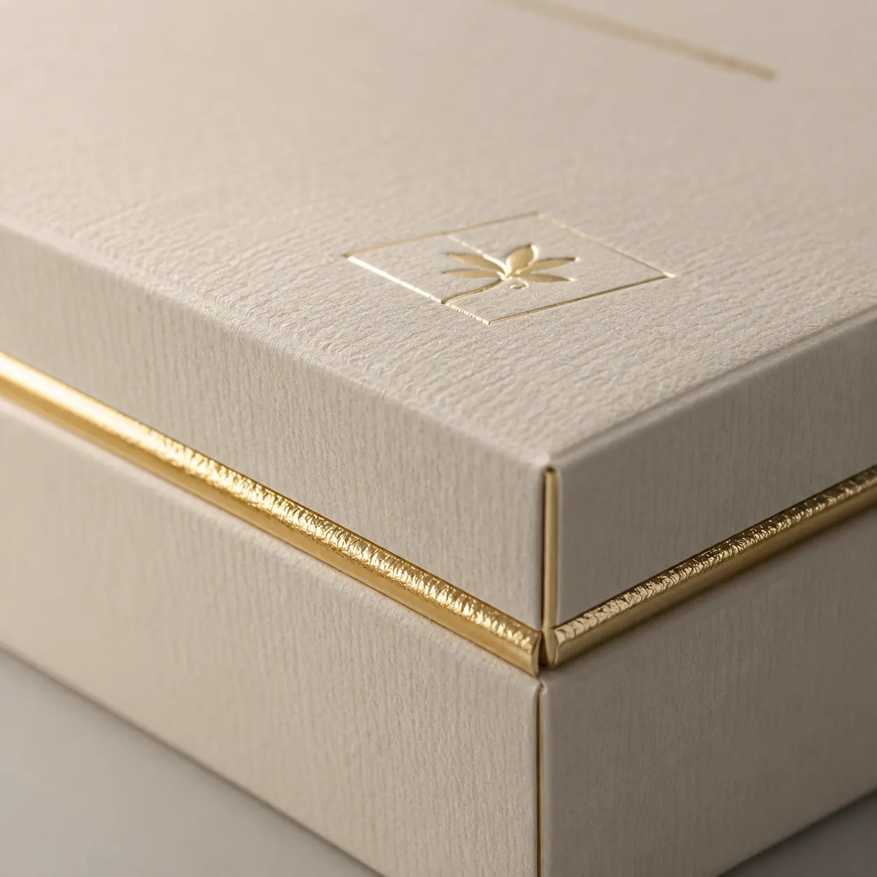 Rigid box with textured paper and foil edge detail