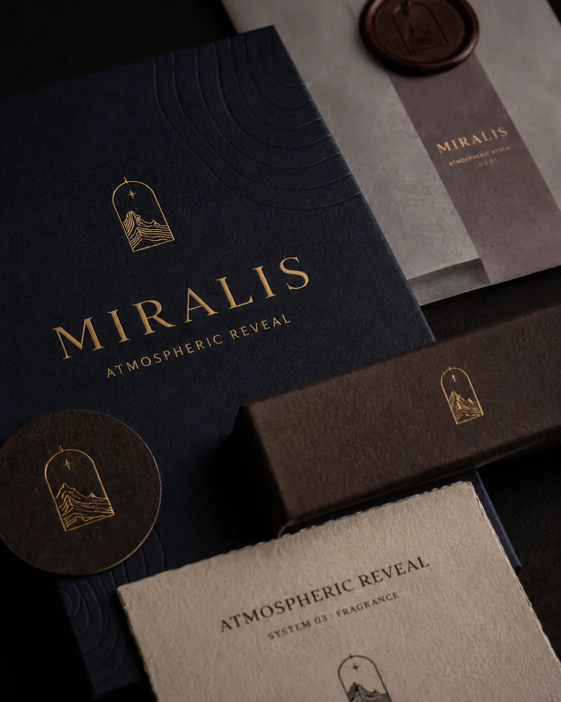Printed collateral flat lay - deckle-edged information cards, branded tissue paper and logo seal arrangement